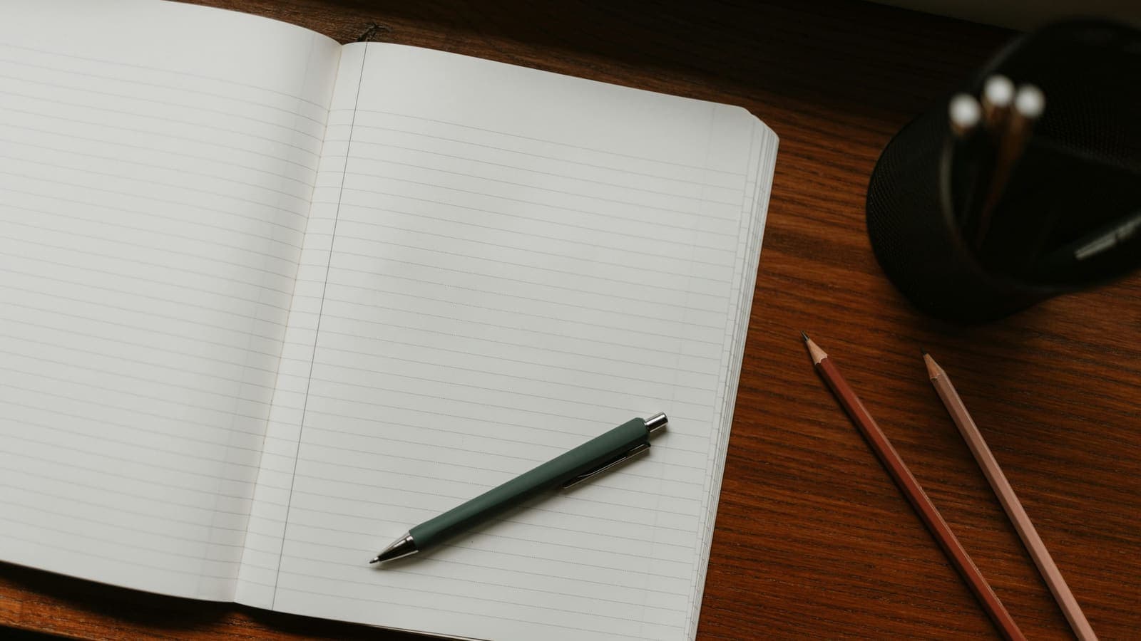 Notebook with hand-drawn marketing charts and a pen on a desk